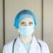 a female doctor wearing a blue surgical mask