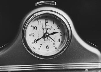 black and white analog alarm clock