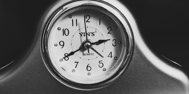 black and white analog alarm clock