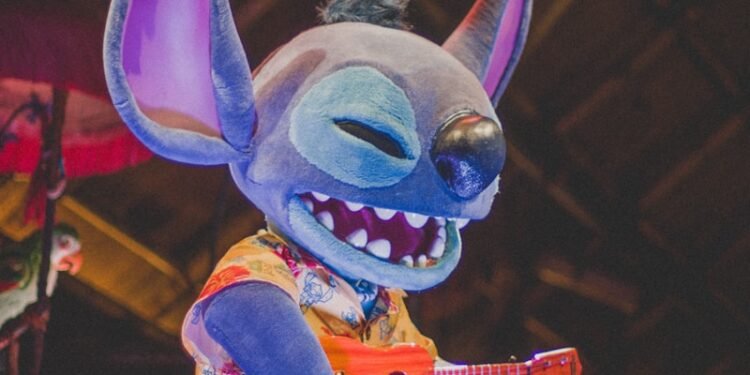 a stuffed animal with a guitar in it's mouth